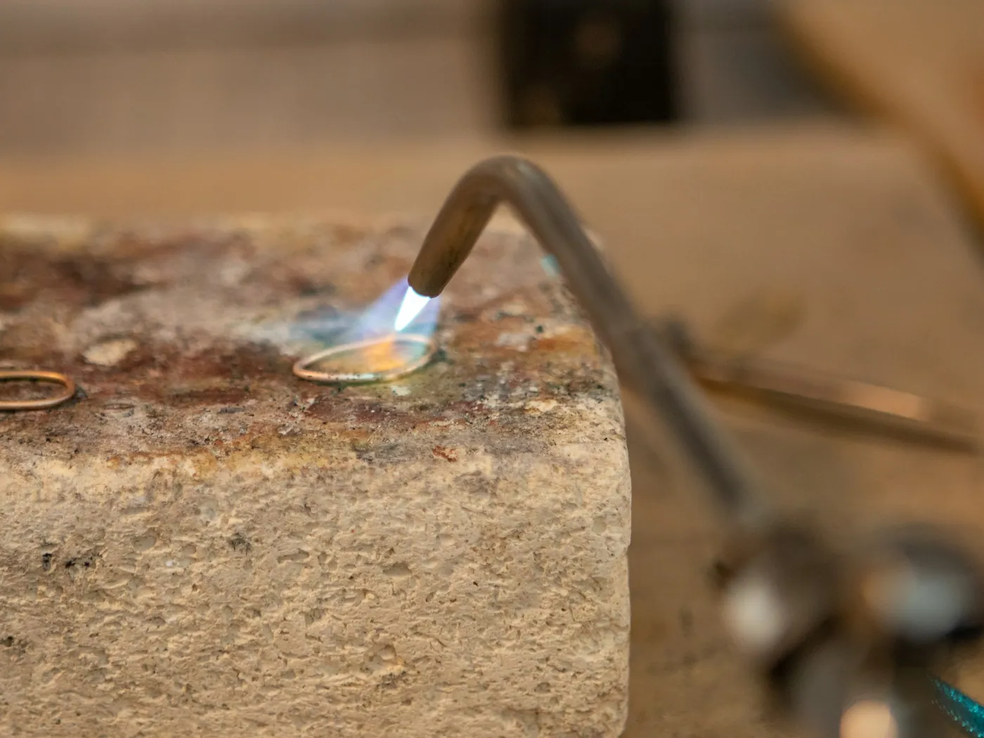 A ring being soldered at the bench